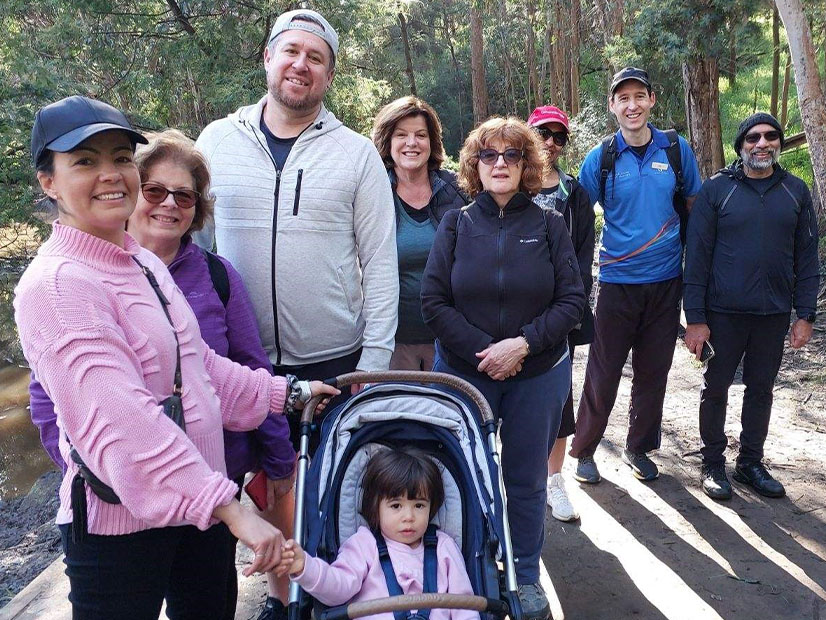 Families smiling at camera during nature walk